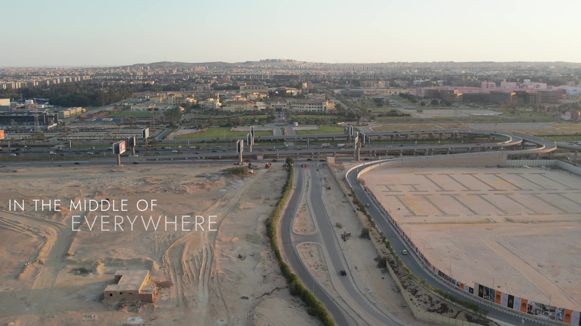 Aerial drone frame over The Vie — the palace, lake and grounds from above.